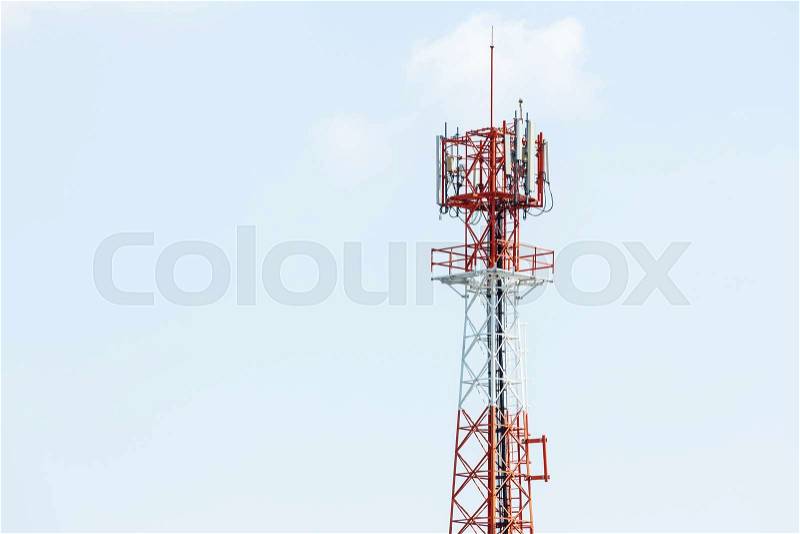 Red and white color antenna repeater tower on blue sky, stock photo