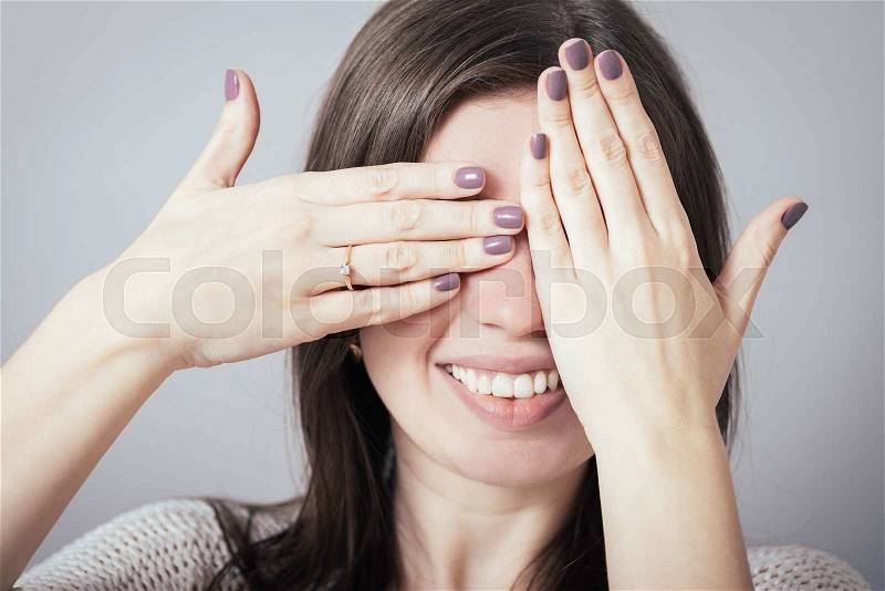 Girl closes eyes hands, stock photo