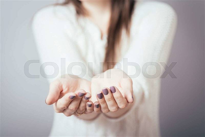 Girl holding in his hands something invisible, stock photo