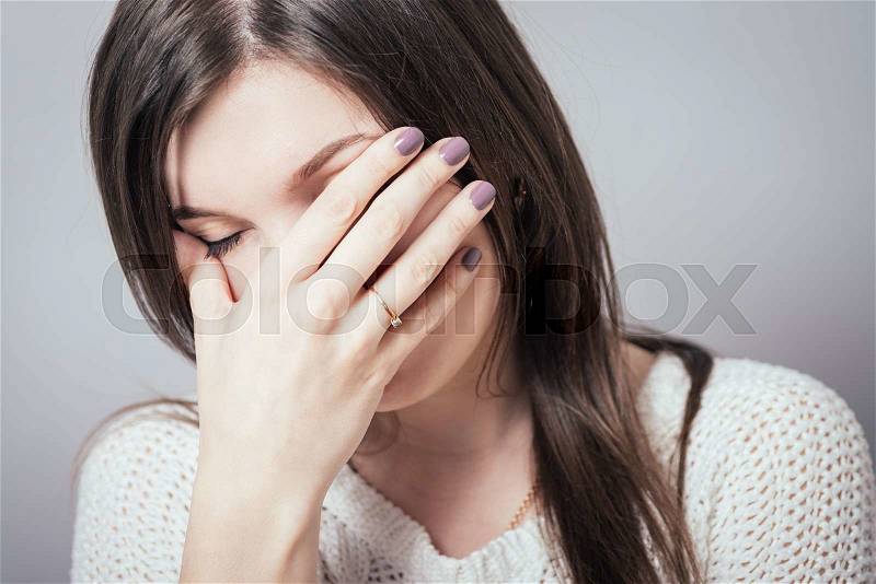 Close-up portrait of surprised attractive businesswoman covering her mouth by the hands, over white background, stock photo
