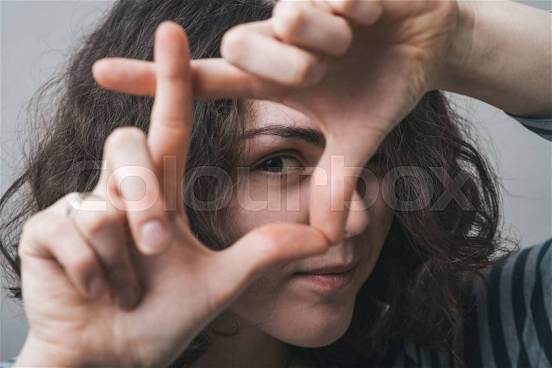 Girl doing hand frame, stock photo