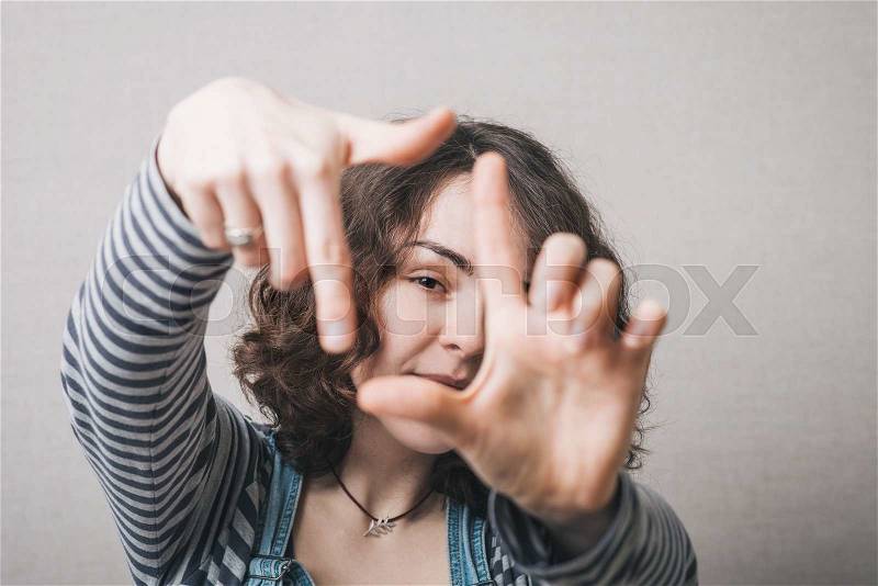 Girl doing hand frame, stock photo