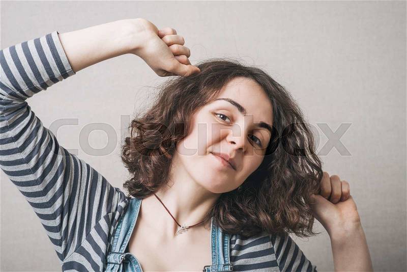A woman wants to sleep, stretching. Gray background, stock photo