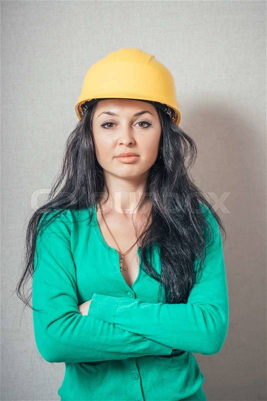 Young female architect or builder wearing a yellow hat , stock photo
