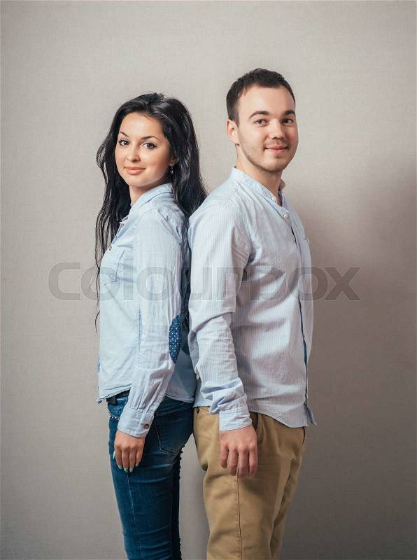 Lovely young couple back to back, stock photo