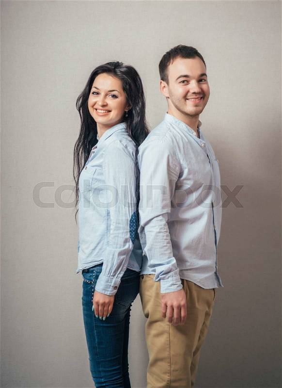 Lovely young couple back to back, stock photo