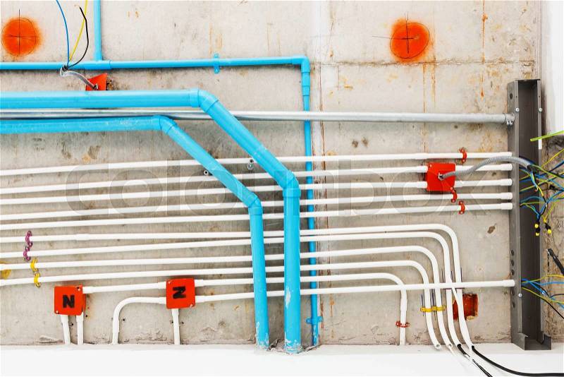 Close up electrical and sanitary distribution system installation in new building, stock photo