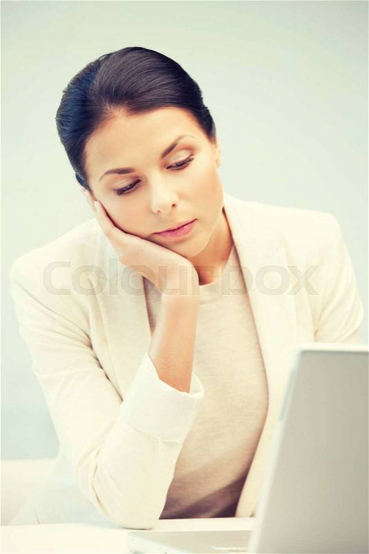 Picture of pensive woman with laptop computer, stock photo