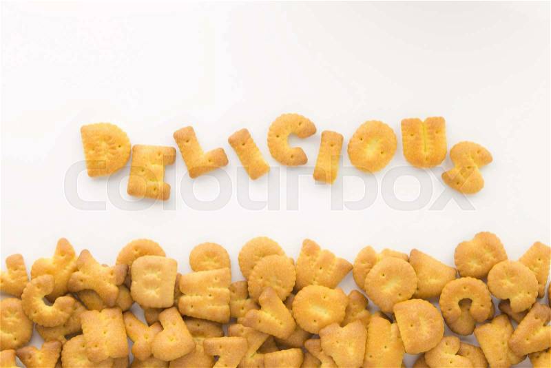 Top view of letter cookies the word DELICIOUS and group of mix alphabet biscuits putting on white background, stock photo