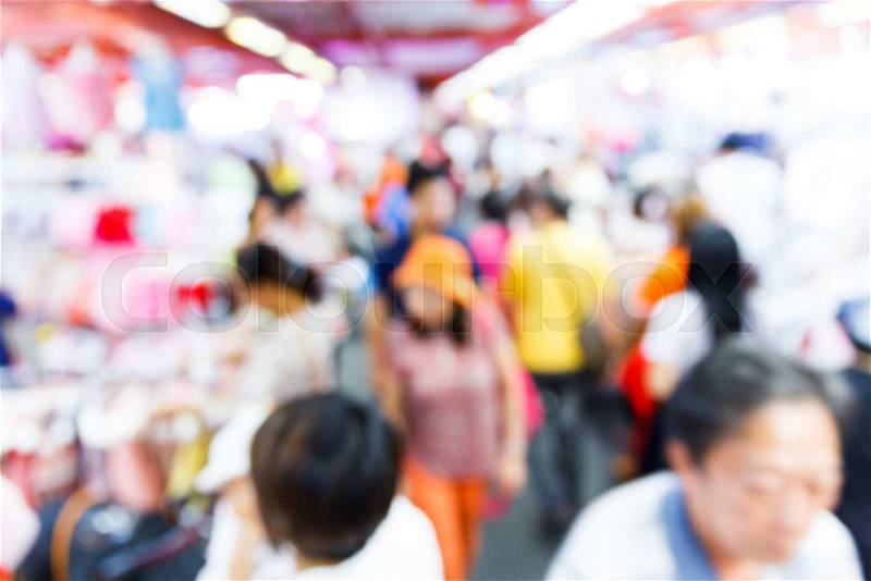 Abstract blurred people walking in shopping centre, stock photo
