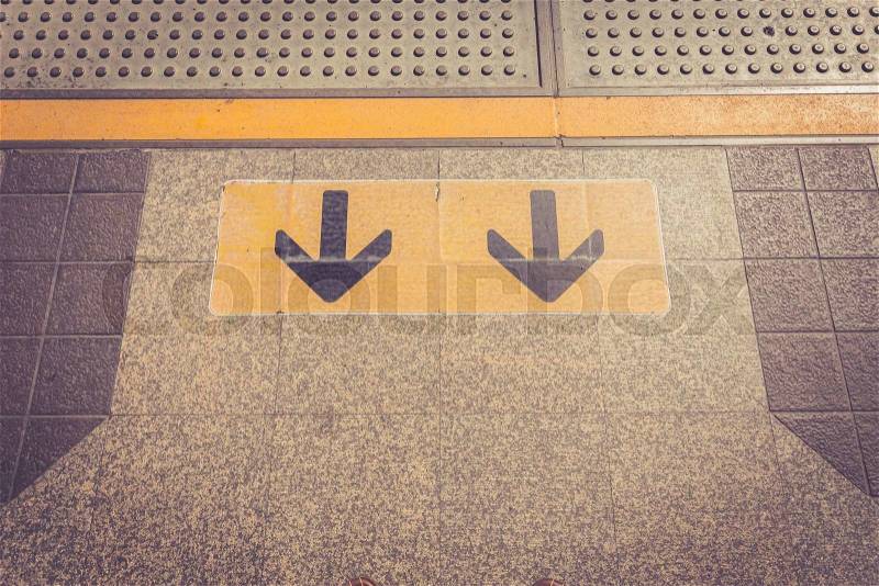 Close up Arrow sign on floor at the sky train station, bangkok, Thailand, stock photo
