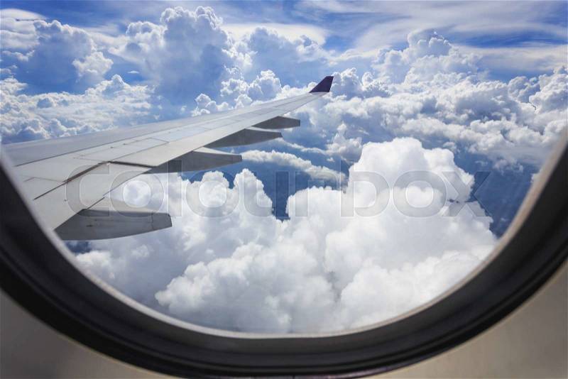 View of beautiful cloud and wing of airplane from window, stock photo