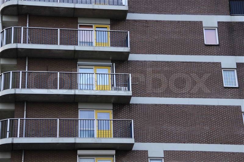 Apartments building with yellow doors in the city, stock photo