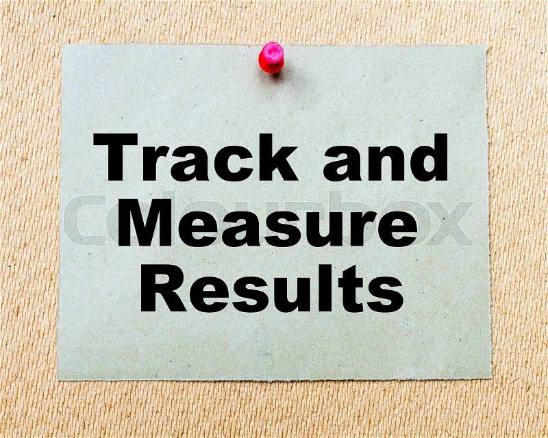Track And Measure Results written on paper note pinned with red thumbtack on wooden board. Business conceptual Image, stock photo
