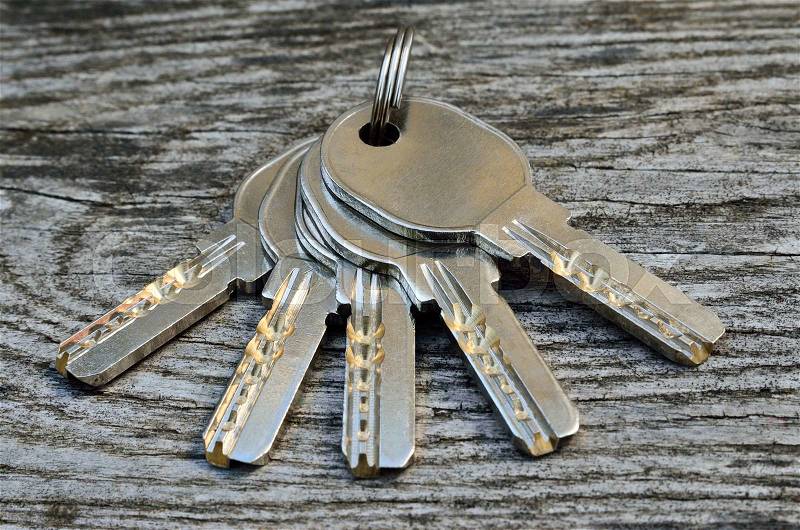 Bunch of keys on a wooden background, close-up, stock photo