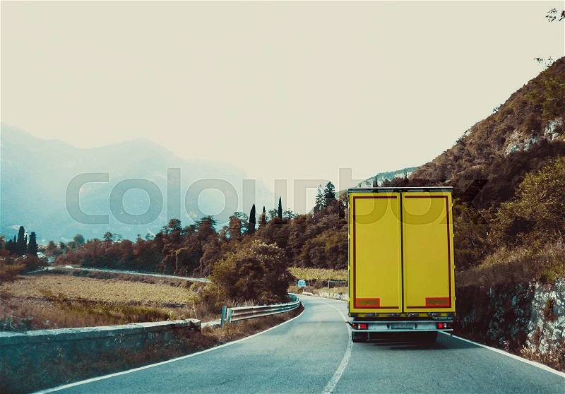 Truck on the road. Yellow cargo car, stock photo