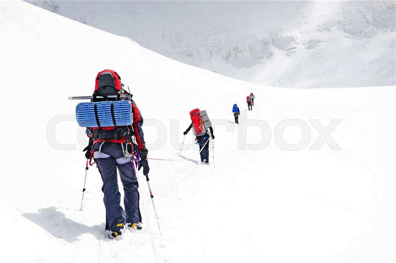 Group of climbers reaching the summit, stock photo