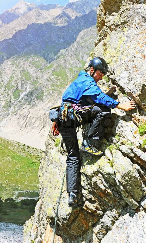 Young man climbing natural rocky, stock photo