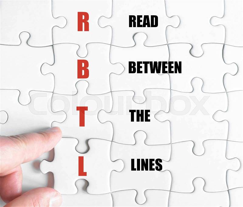 Hand of a business man completing the puzzle with the last missing piece.Concept image of Business Acronym RBTL as Read Between The Lines, stock photo
