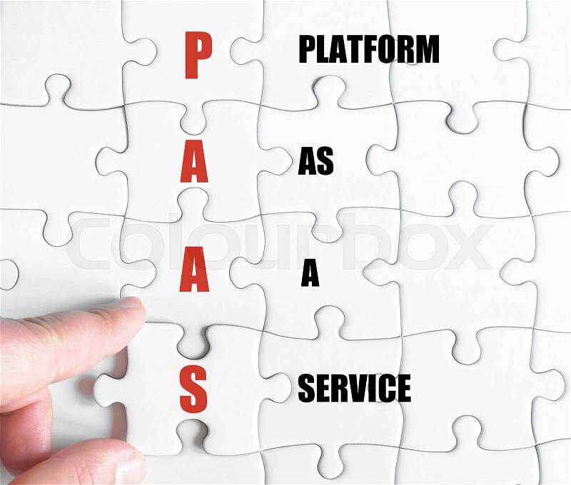 Hand of a business man completing the puzzle with the last missing piece.Concept image of Business Acronym PAAS as Platform As A Service, stock photo