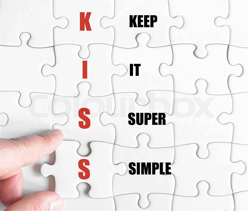 Hand of a business man completing the puzzle with the last missing piece.Concept image of Business Acronym KISS as Keep It Super Simple, stock photo