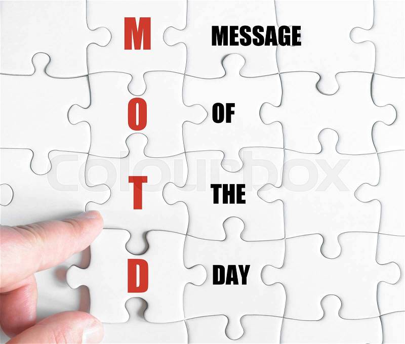 Hand of a business man completing the puzzle with the last missing piece.Concept image of Business Acronym MOTD as Message Of The Day, stock photo