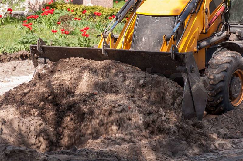 Excavator works with the earth closeup, stock photo
