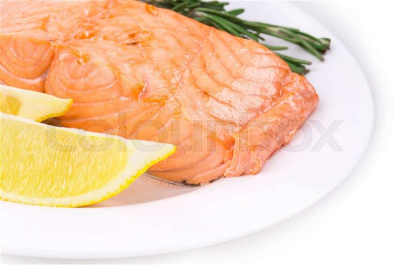 Salmon fillet on plate with lemon. Isolated on a white background, stock photo
