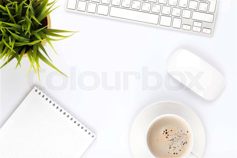 Office desk table with computer, supplies, flower and coffee cup. Top view with copy space, stock photo