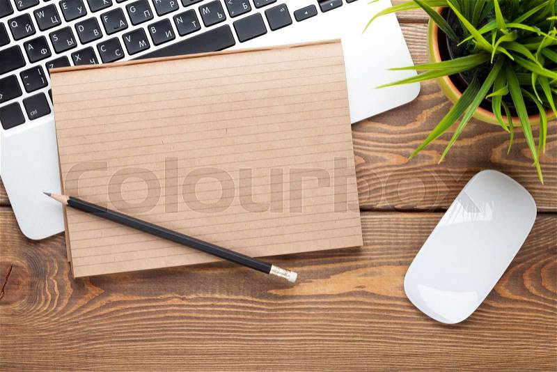Office desk table with computer, supplies and flower. Top view with copy space, stock photo
