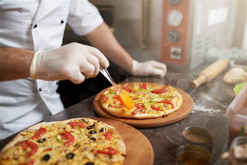 Cook misses edge freshly prepared pizzas oil, stock photo