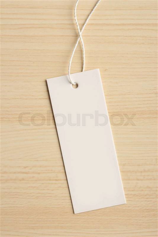 Blank label is on the wooden textured background, stock photo