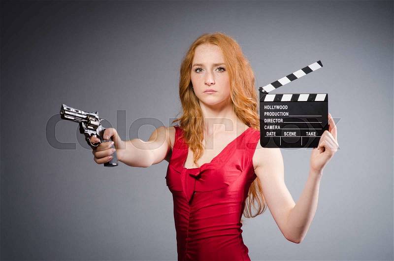 Pretty young girl in red dress with gun isolated on white, stock photo