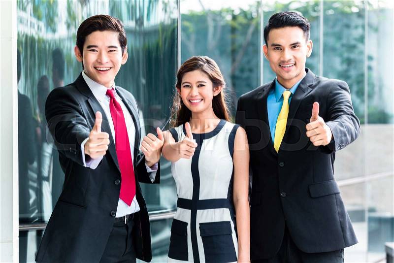 Asian business woman and men outside in front of building , stock photo