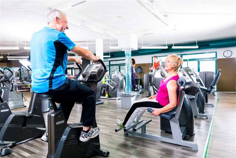 Senior man and woman in circle training doing sport exercising in gym , stock photo