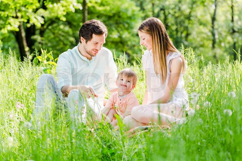 Family protecting child taking son in the middle, stock photo