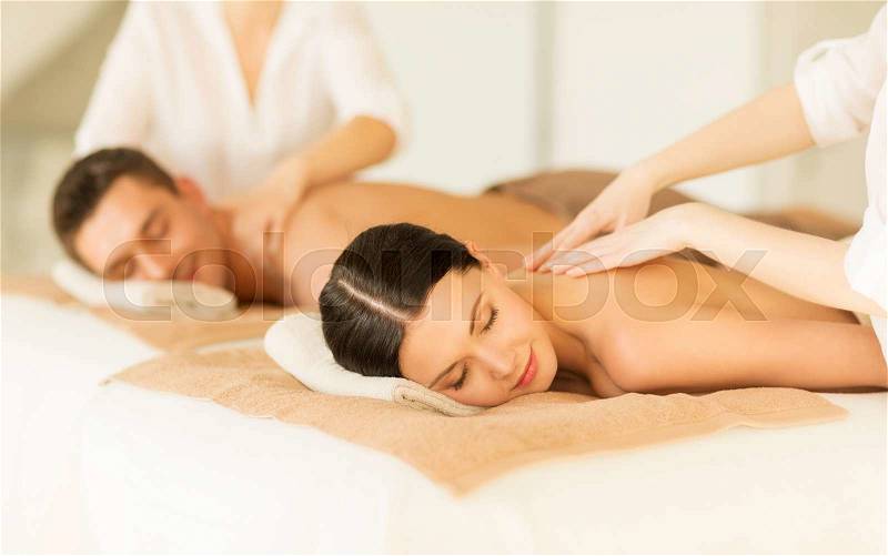 Picture of couple in spa salon getting massage, stock photo