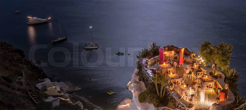 Terrace in front of the ocean. Restaurant with sea view at night, stock photo