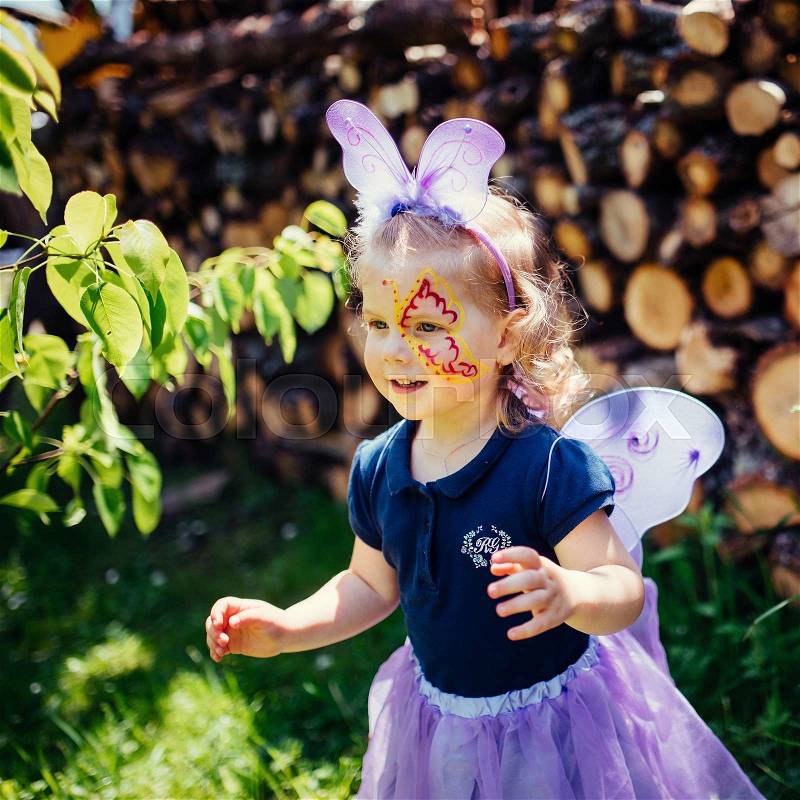Beautiful girl in a fairy costume with butterfly wings, stock photo