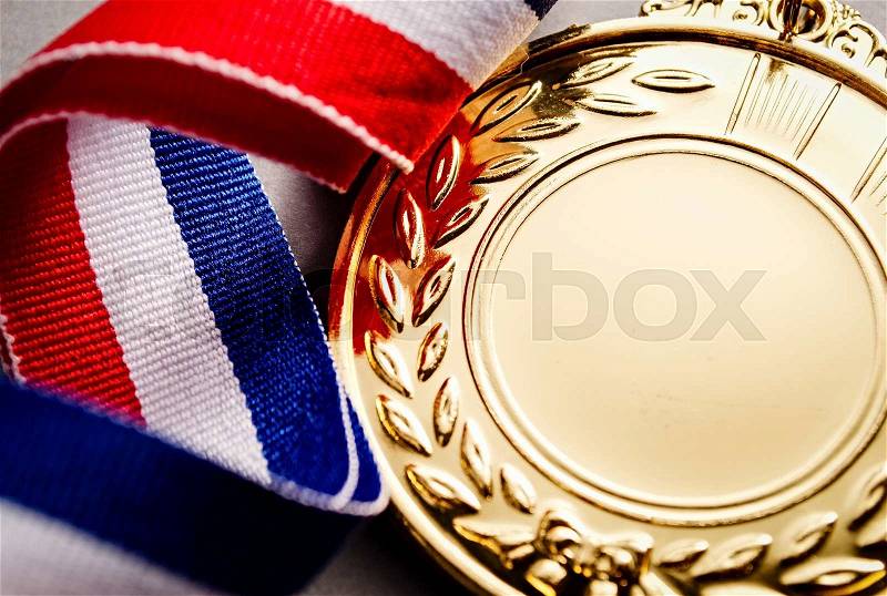 Gold medal with blank face for text, concept for winning or success, stock photo