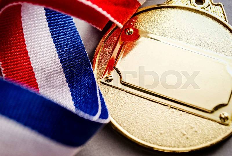 Gold medal with blank face for text, concept for winning or success, stock photo