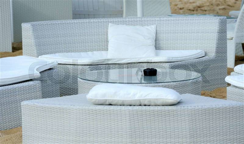 Luxury beach furniture and table on tropical island beach, stock photo
