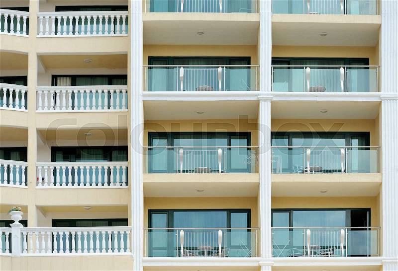 Pattern of hotel room balconies in modern building, stock photo