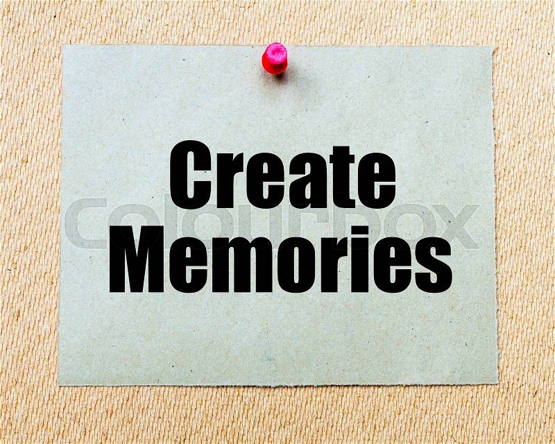 Create Memories written on paper note pinned with red thumbtack on wooden board. Motivation conceptual Image, stock photo
