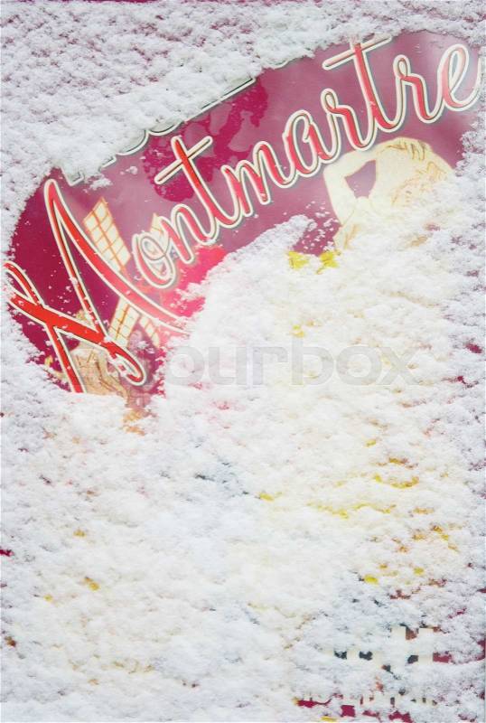 Rare snowy day in Paris. Poster with word Montmartre covered with snow, stock photo
