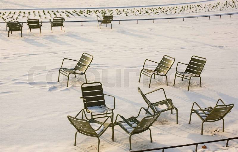 Rare snowy day in Paris. Lots of snow and chairs in the Luxembourg Garden, stock photo