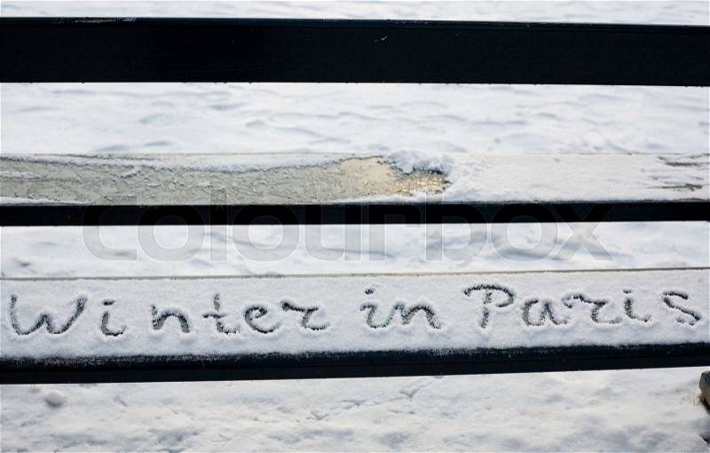 Rare snowy day in Paris. Handwriting on a bench covered with snow in the Luxembourg garden, stock photo