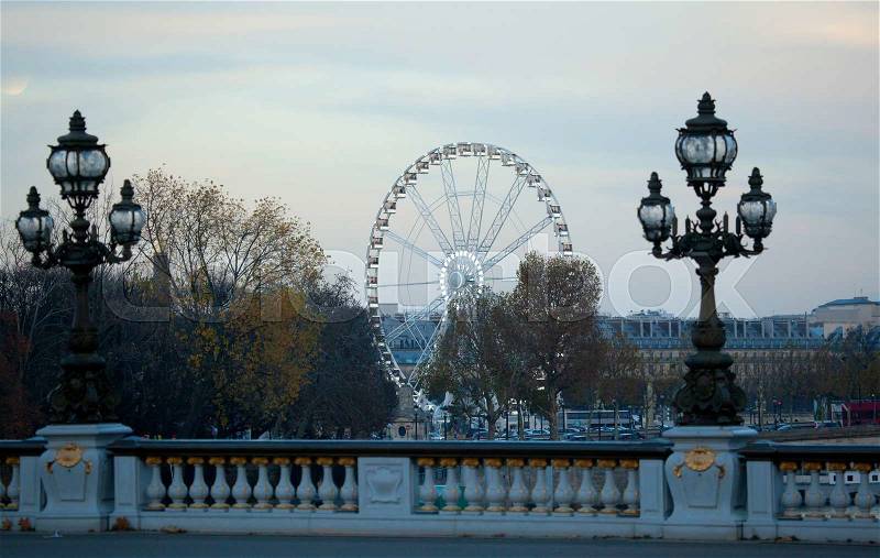 Winter season in Paris. The observation wheel on the Concorde square, seen from the Pont Alexandre III, stock photo