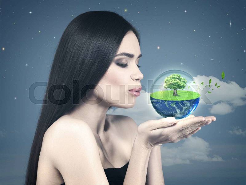 Eco female portrait with beauty white girl holding green planet on to his palm, stock photo