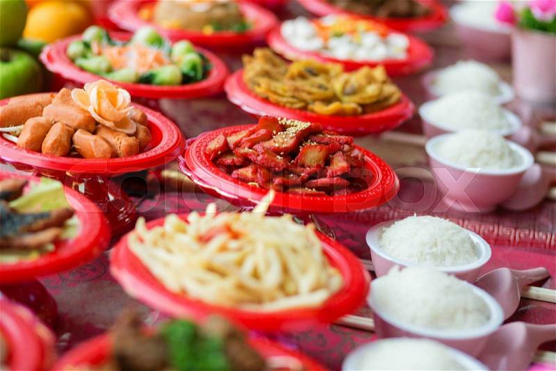 Food plates near the Chinese temple in Singapore, prepared for the believers, stock photo